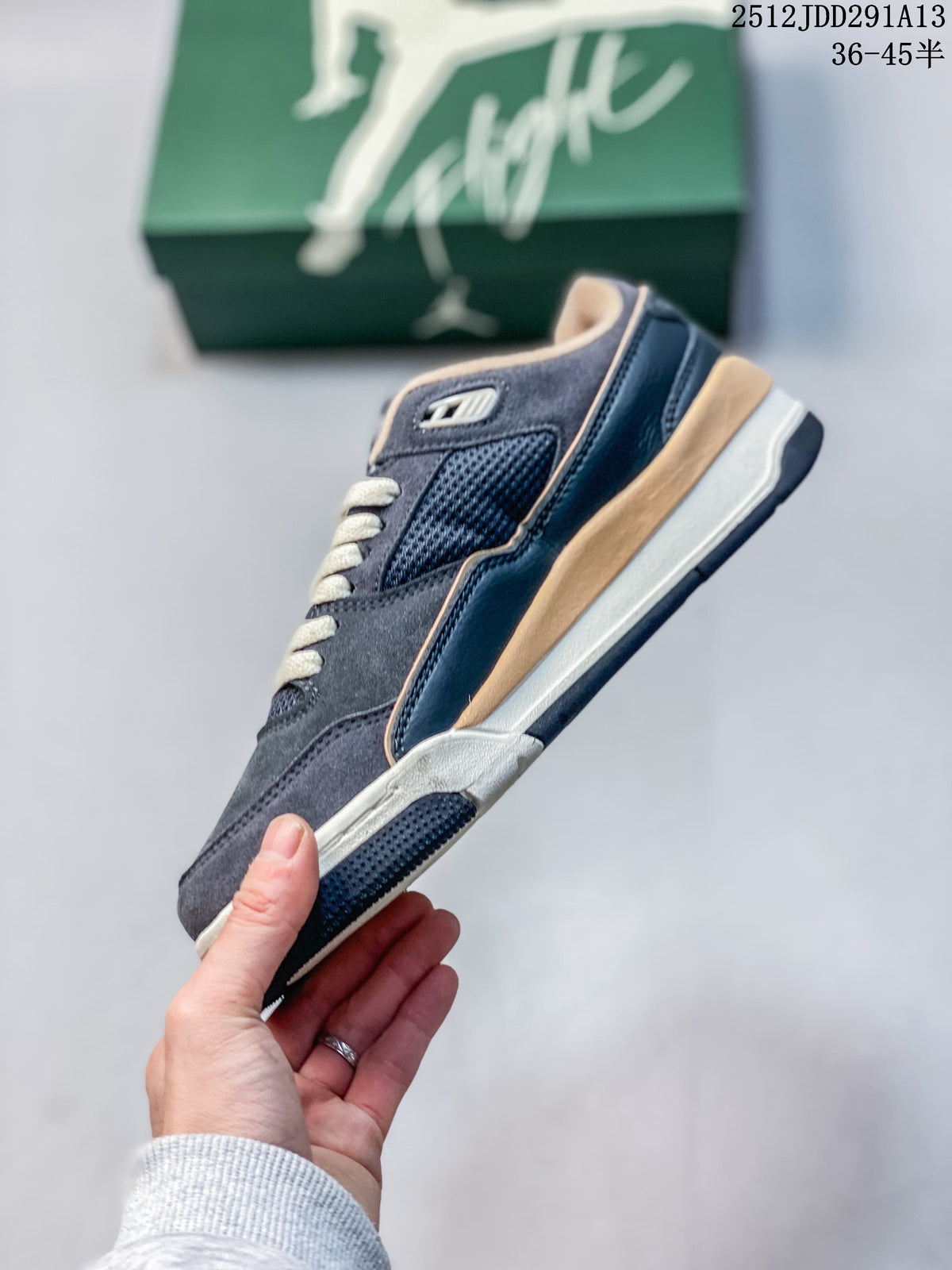 Side profile of a charcoal and navy Jordan Flight Court ATE low-top sneaker with cream and tan details