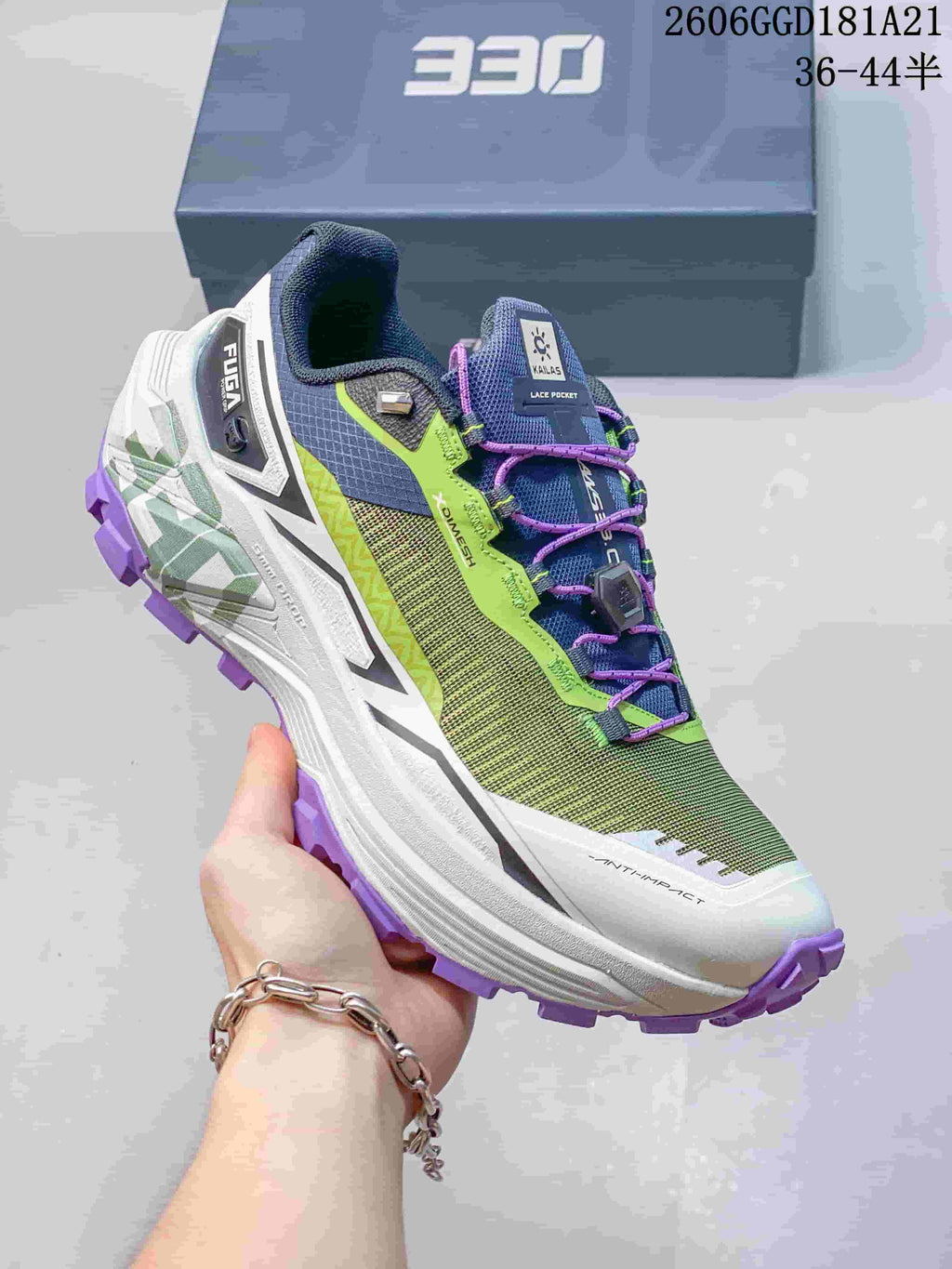 Side view highlighting the dial closure, green and navy upper, and purple outsole; image text shows 36–44.5.