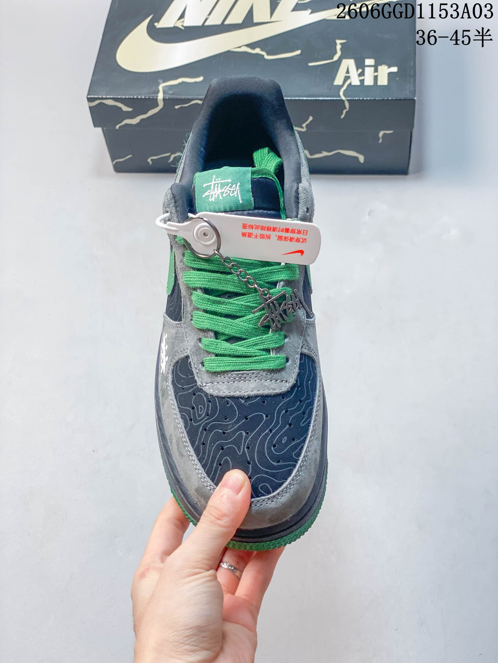 Top view of the Nike Air Force 1 sneakers with green laces and patterned toe panels