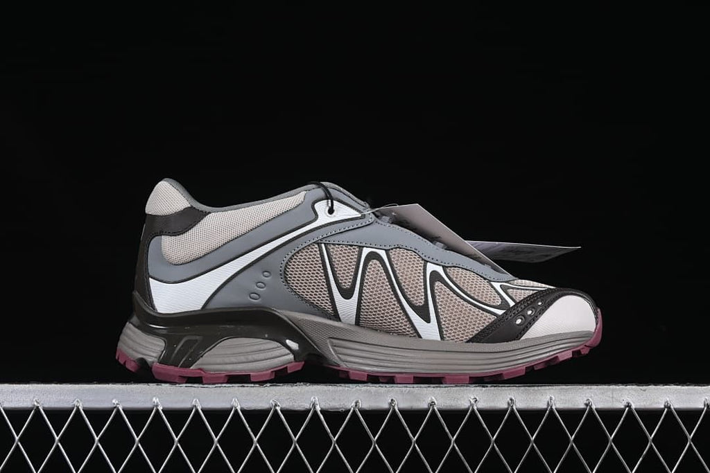 Side profile of the shoe showing layered panels and the lugged outsole.