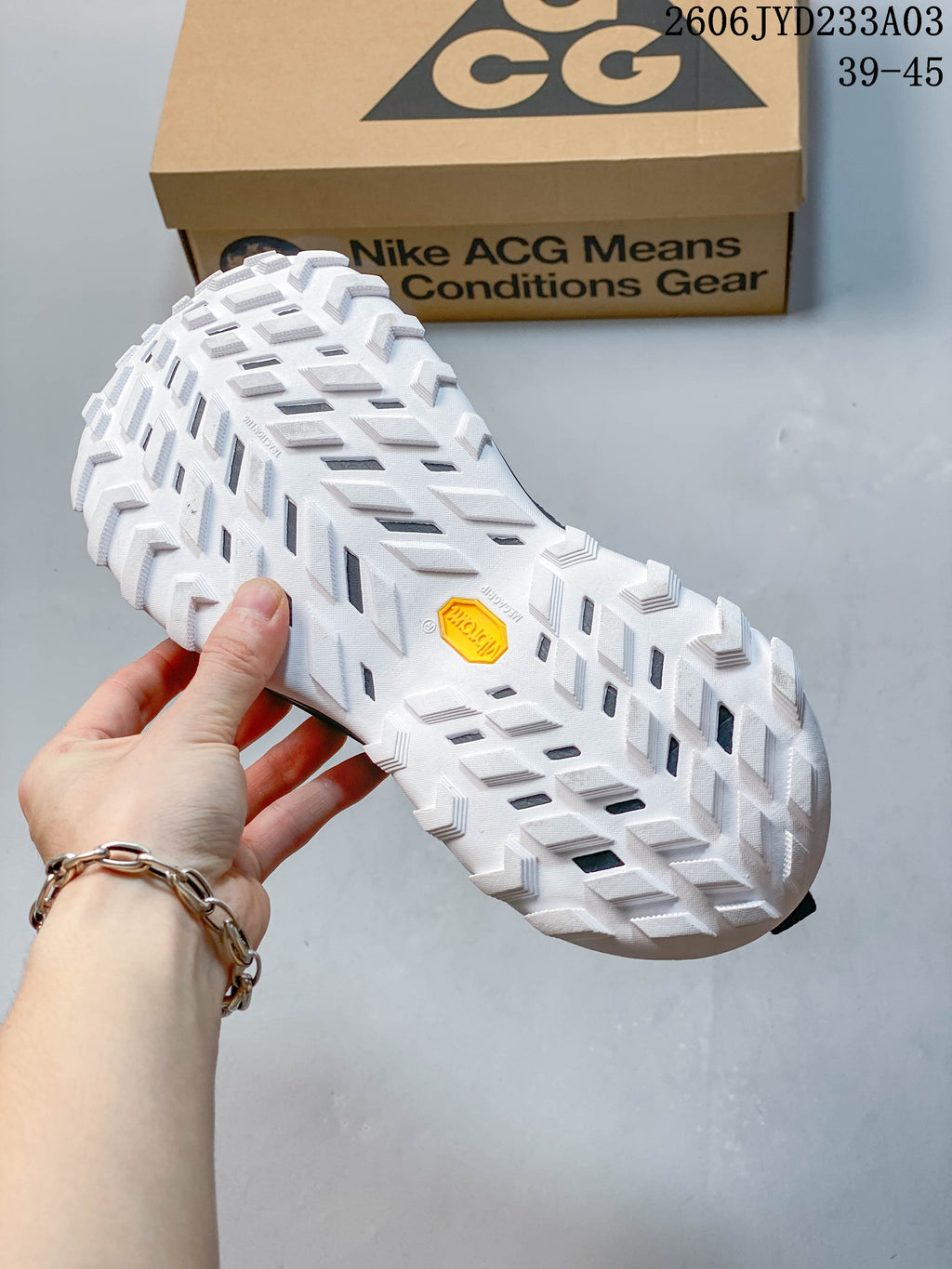 Close-up of the shoe's white outsole and deep tread