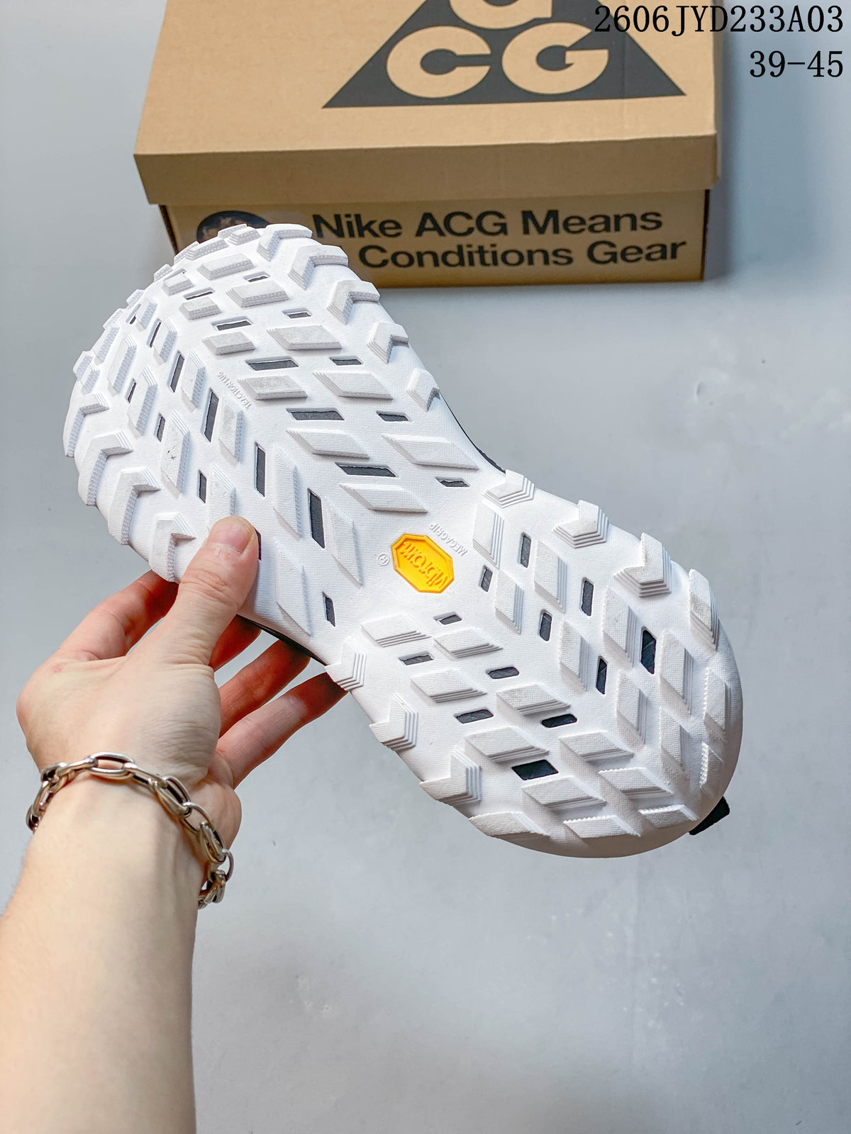Close-up of the shoe's white outsole and deep tread