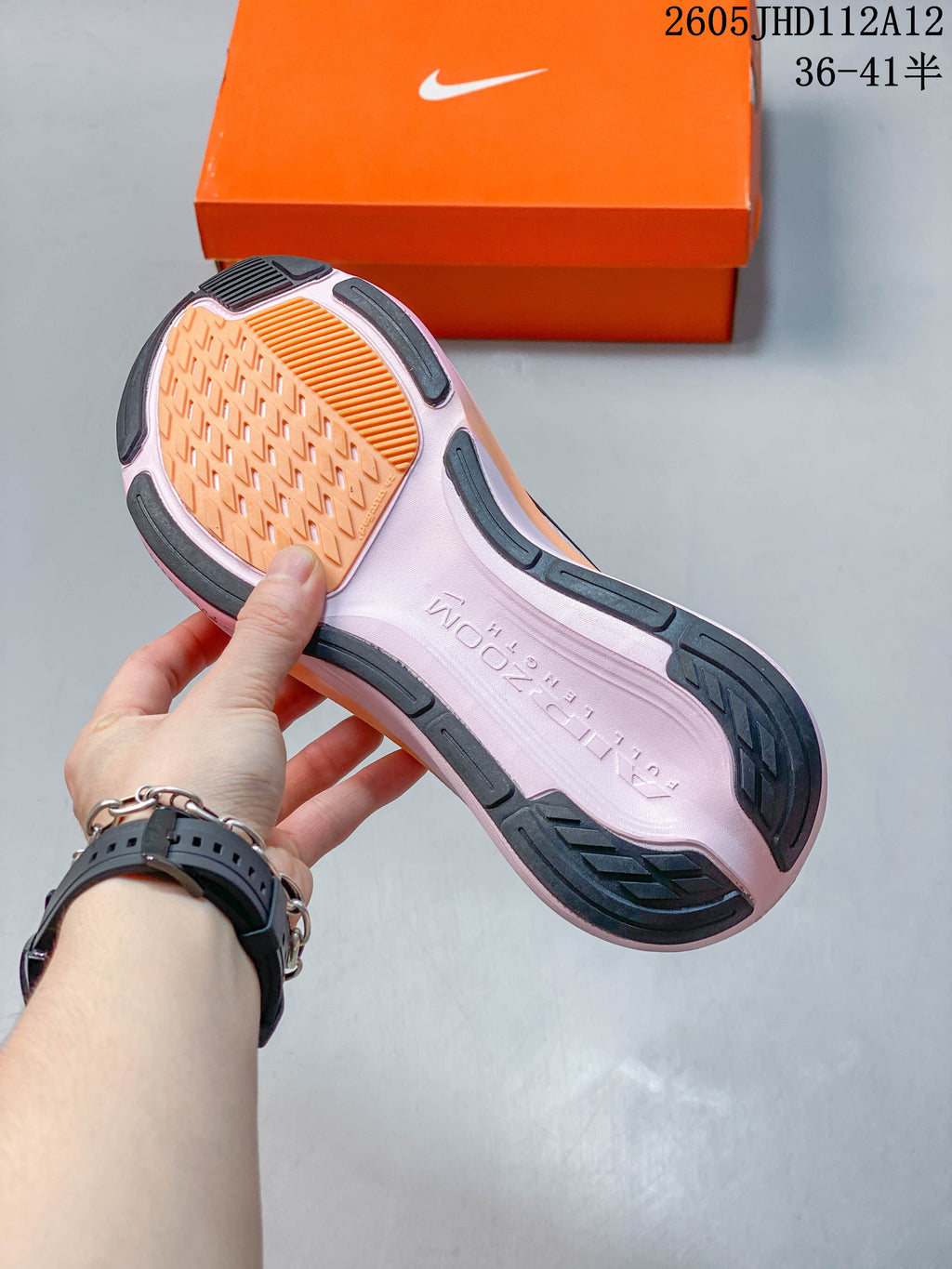 Outsole view of the white and pink Nike Air Zoom Pegasus 42 shoe.