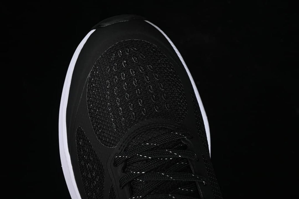 Top view of the black mesh toe and lacing