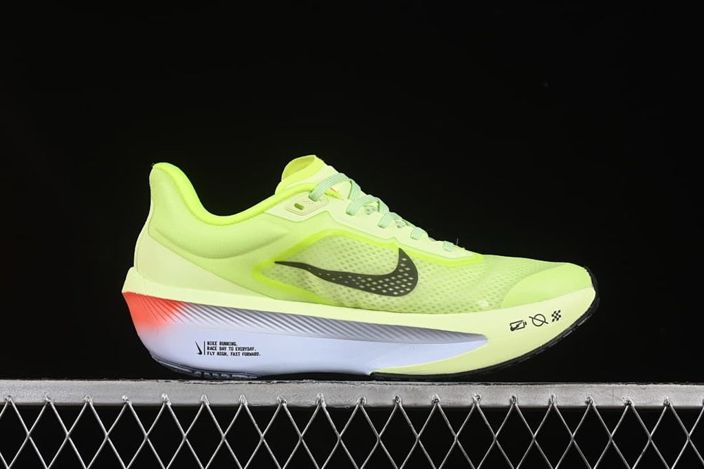 Outer side view showing the Swoosh and pale sole with a coral heel accent.