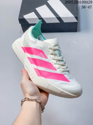 White Adidas running sneaker with bright pink stripes and a turquoise heel accent.
