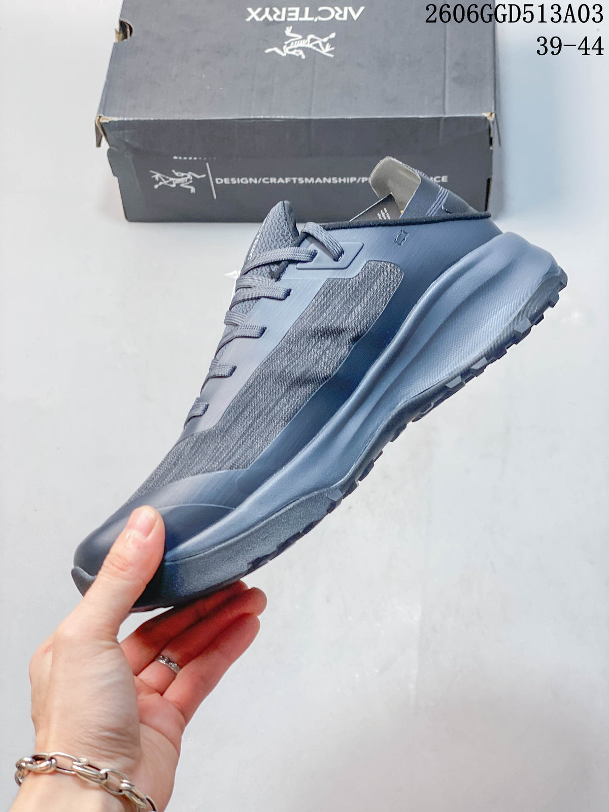 Side profile of the gray-blue low-top shoe with lace-up closure and textured panels.