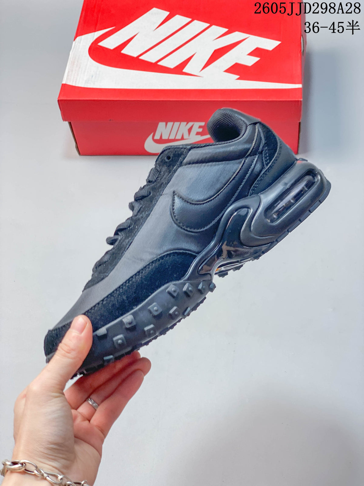 Side view of a dark gray low-top sneaker with a visible heel air unit