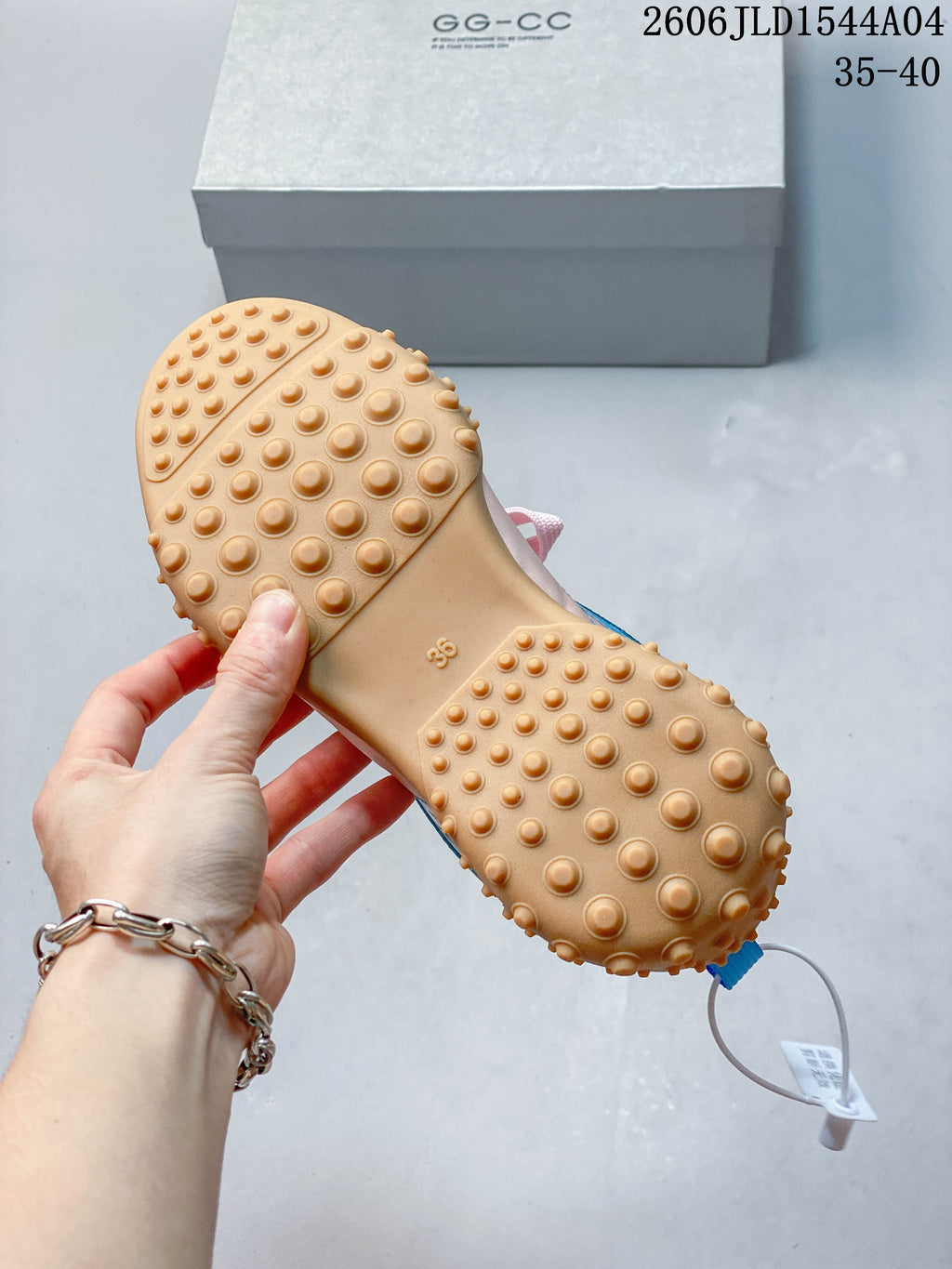 Close-up of the tan outsole with rounded raised tread and a visible EU 38 marking.