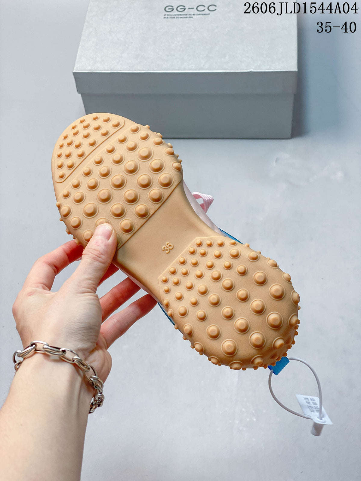 Close-up of the tan outsole with rounded raised tread and a visible EU 38 marking.