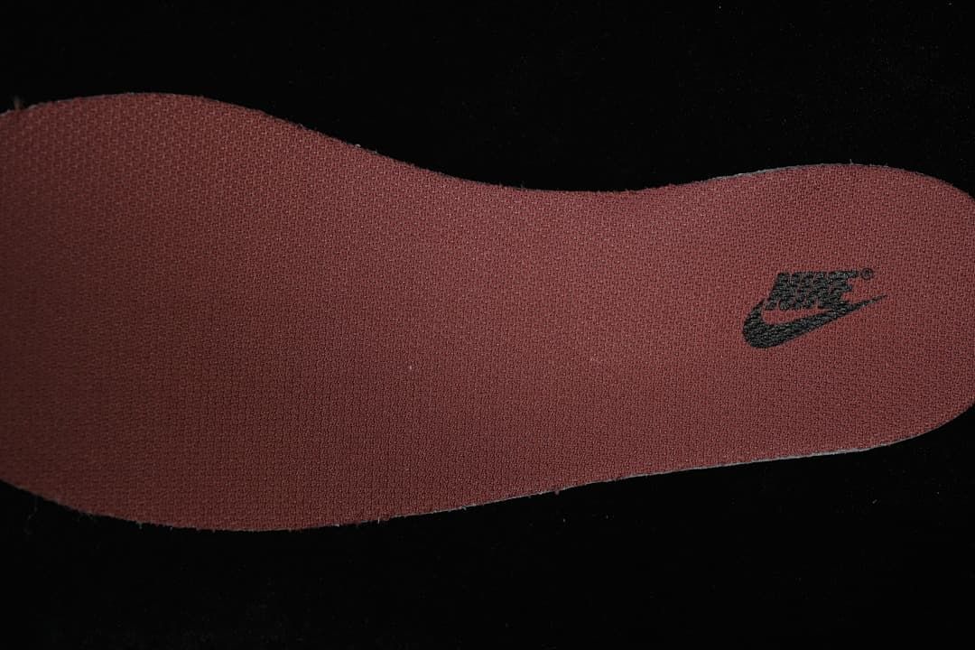 Close-up of a burgundy insole with a Nike logo