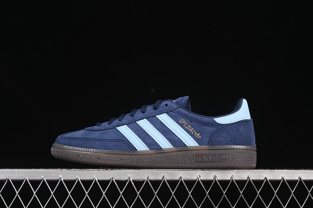 Side view of navy adidas Handball Spezial sneakers with pale blue stripes and brown sole