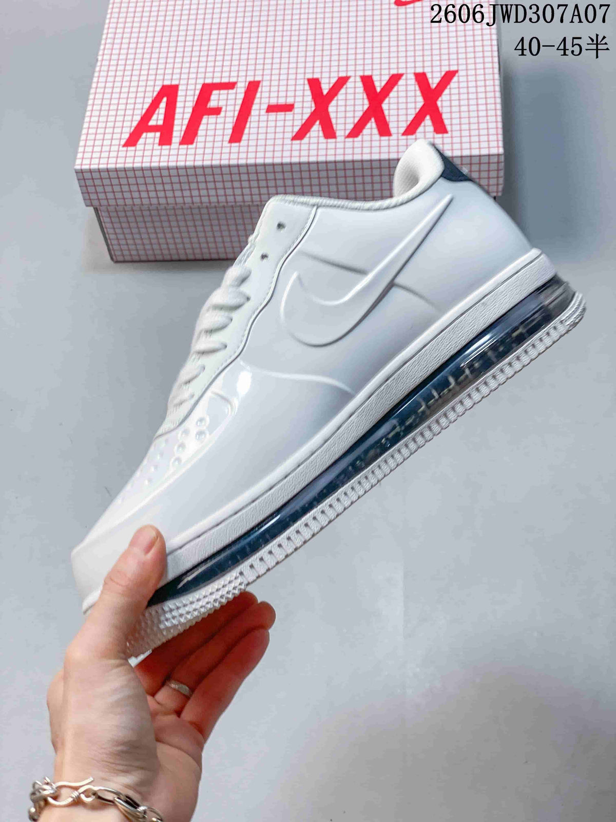 Side view of the white low-top sneaker with a dark Swoosh and visible air unit.