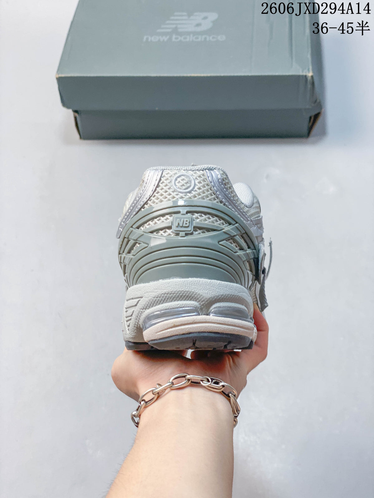 Heel view of a silver-grey New Balance 1906 sneaker.