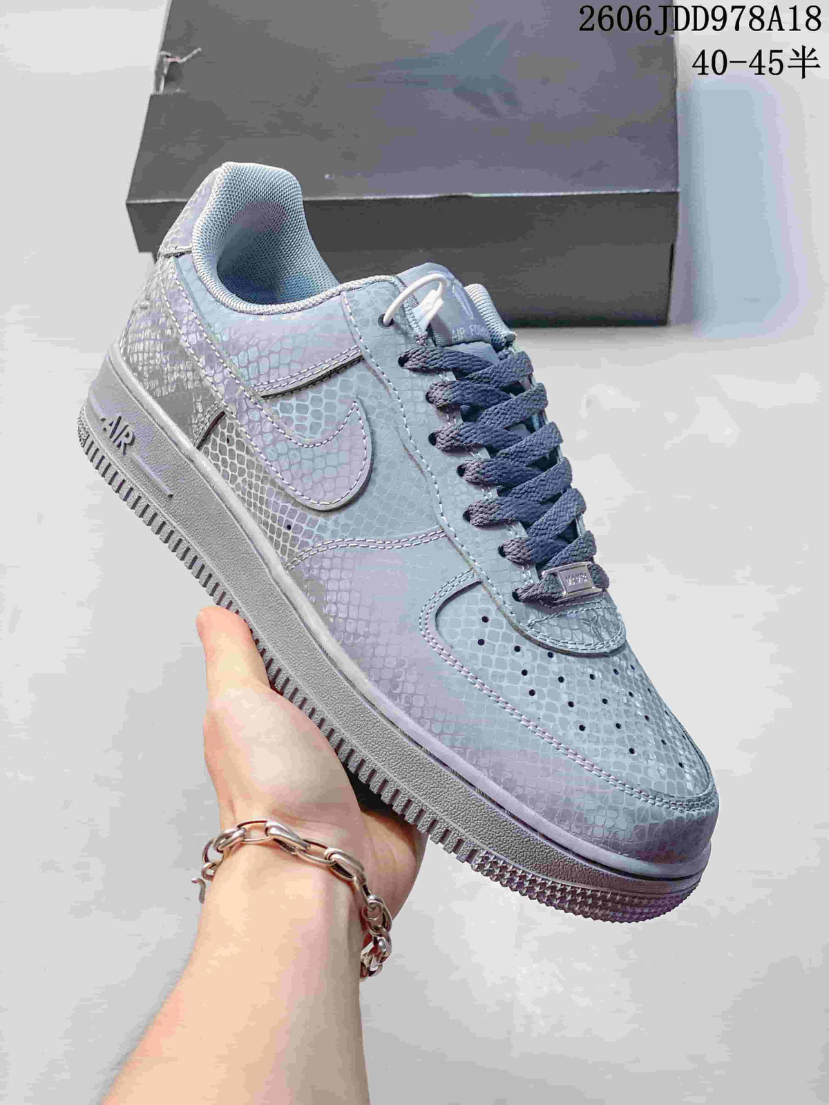 Angled view of a pale blue-gray Nike Air Force 1 low-top sneaker