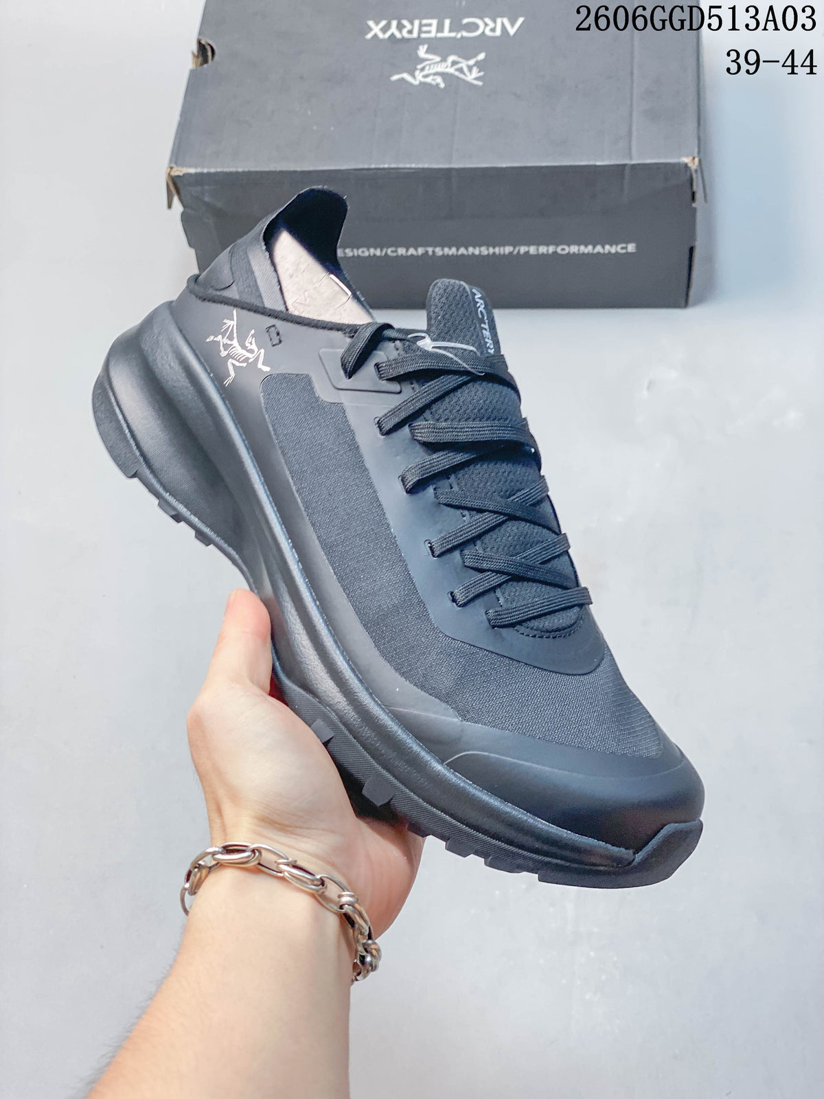 Angled view of a dark gray low-cut outdoor shoe with a lugged outsole