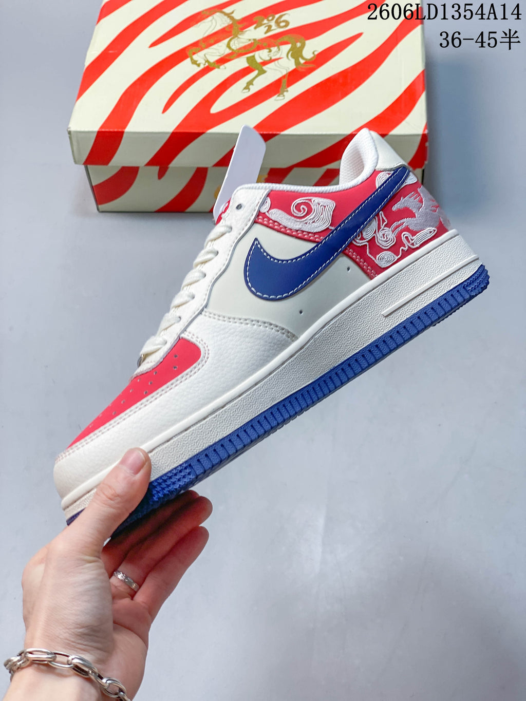 Side view of the sneaker with a blue side logo, embroidered heel panel, and blue outsole.