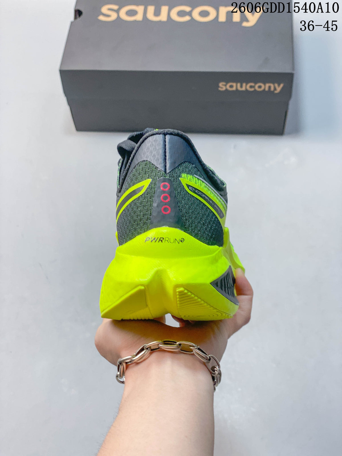 Rear view of the charcoal and neon yellow running shoe showing the heel and sculpted midsole.
