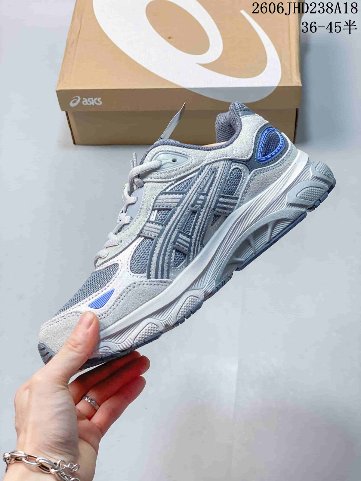 Side view of a grey and blue ASICS GEL-NYC 2.0 sneaker