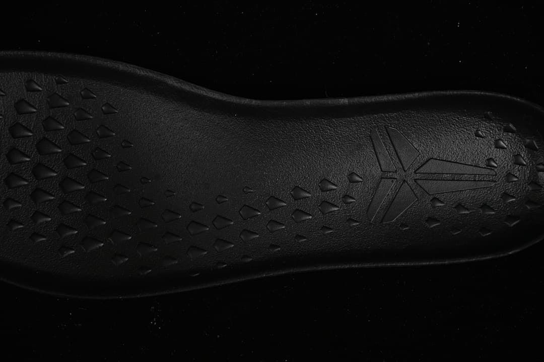 Close-up of black outsole tread and Kobe logo