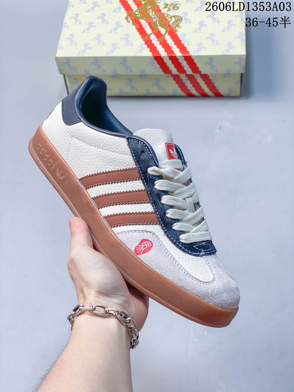 White Gazelle Indoor sneaker with brown and navy accents and a gum-colored outsole.