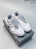 Pair of white and silver Adidas Barricade 13 tennis shoes displayed on a shoebox