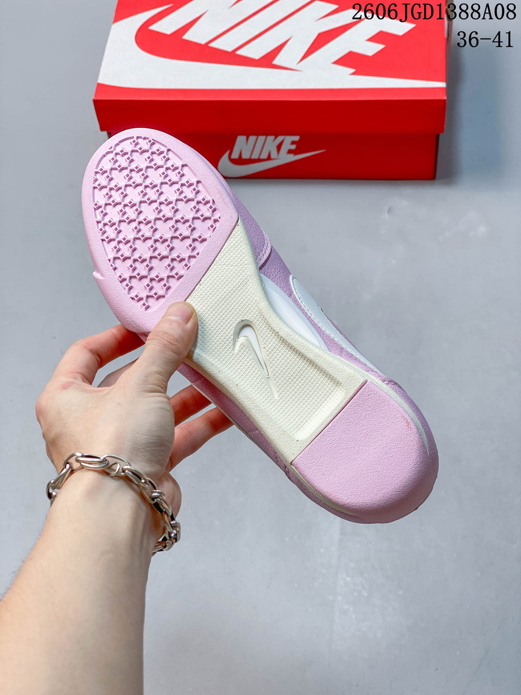 Underside of the pink sneaker showing its patterned outsole