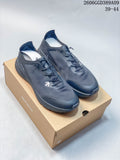 Pair of dark gray Descente running shoes on a branded box, with style code and size range overlaid.