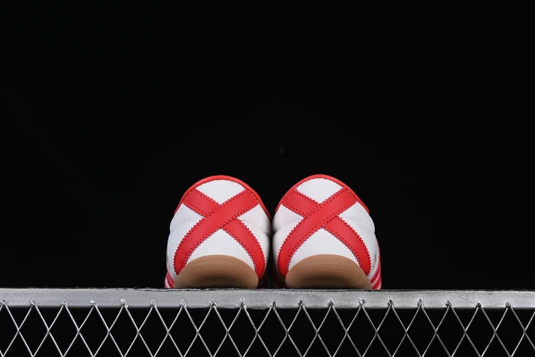 Rear view of both sneakers showing red crossed heel overlays