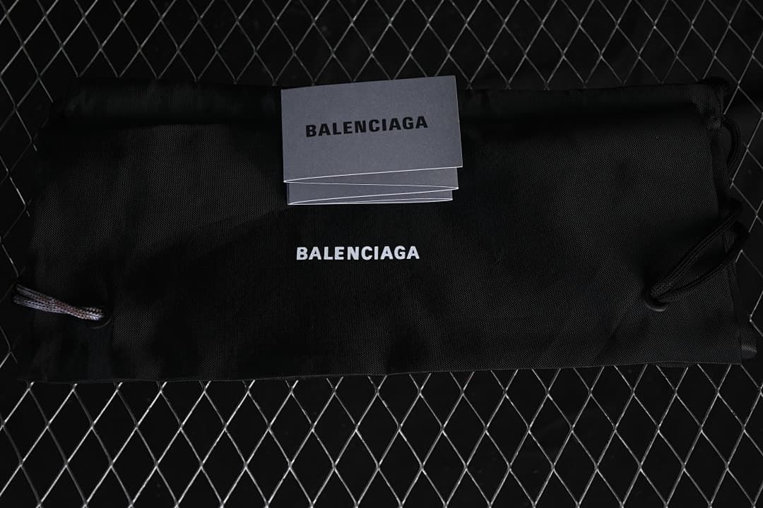 Black dust bag and cards bearing Balenciaga branding