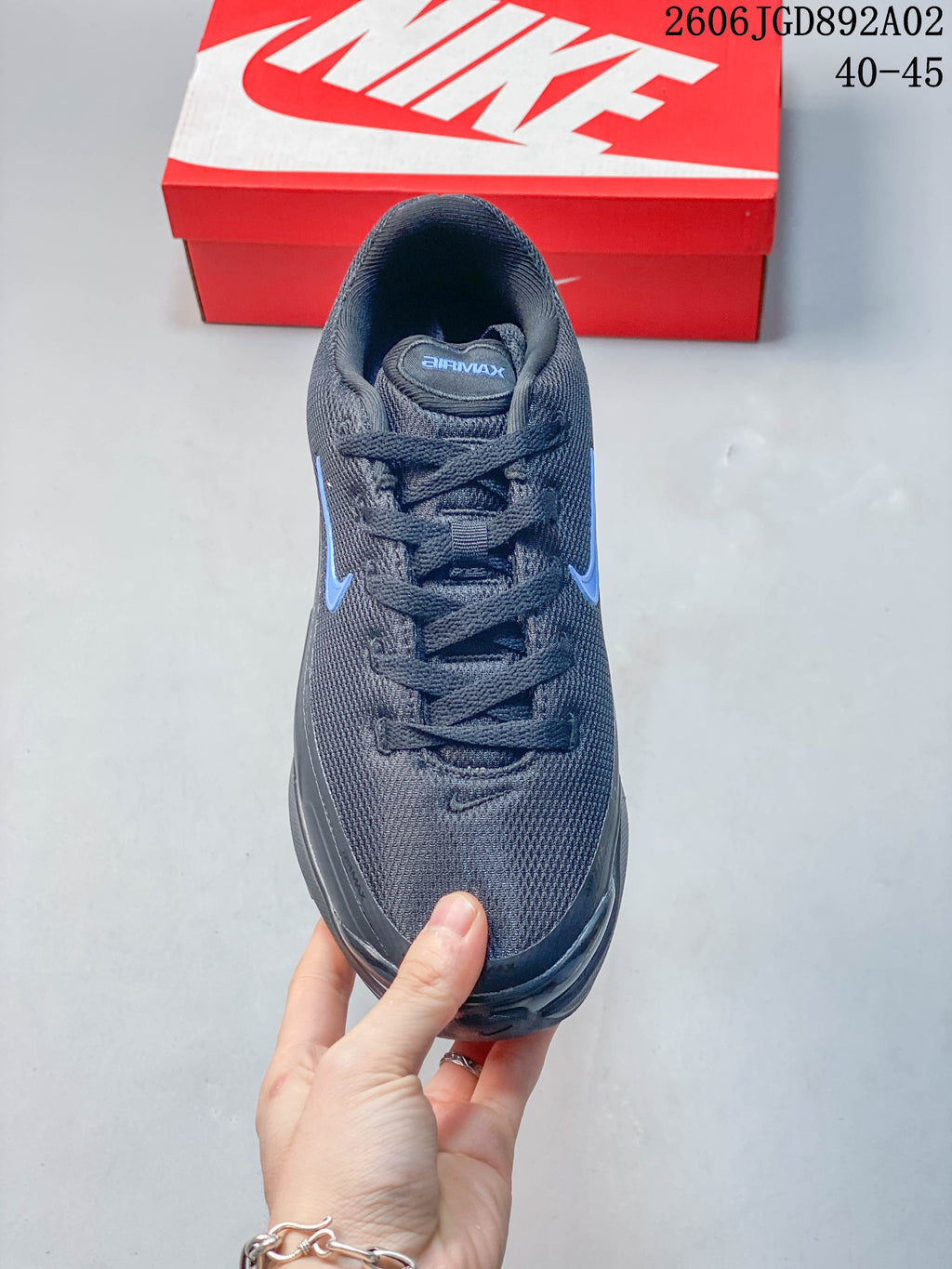 Top view of a dark gray Nike Air Max BIA shoe with blue Swoosh accents