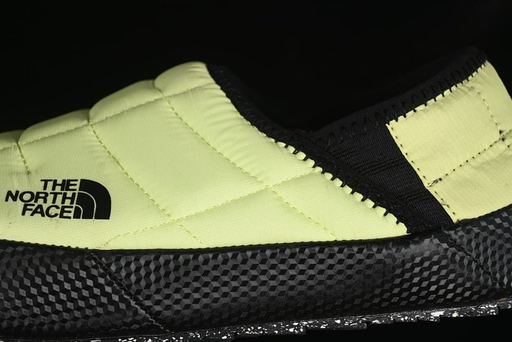 Close-up of the yellow quilted upper, black trim, and side logo.