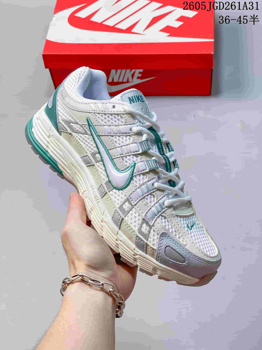 Close-up of a white Nike P-6000 sneaker with teal accents.