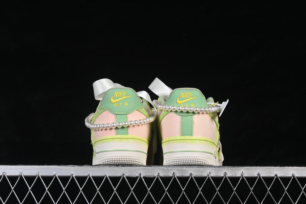 Rear view of both sneakers with pastel heel panels and bead trim