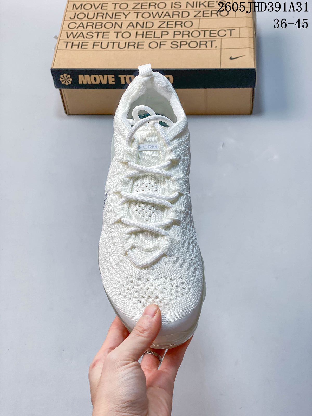 Front view of the white knit shoe with lace-up closure.