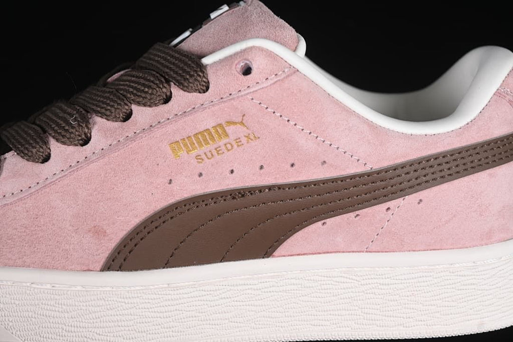 Close-up of the pink upper, brown Formstrip, and side branding.