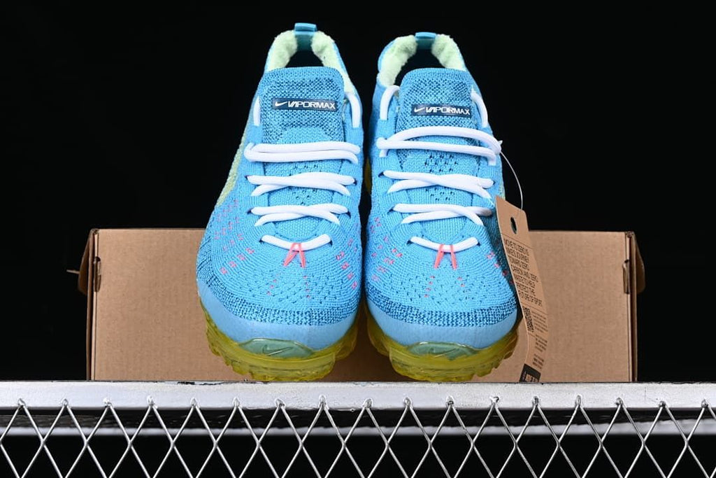 Front view of the pair showing blue knit uppers, white laces and yellow soles.