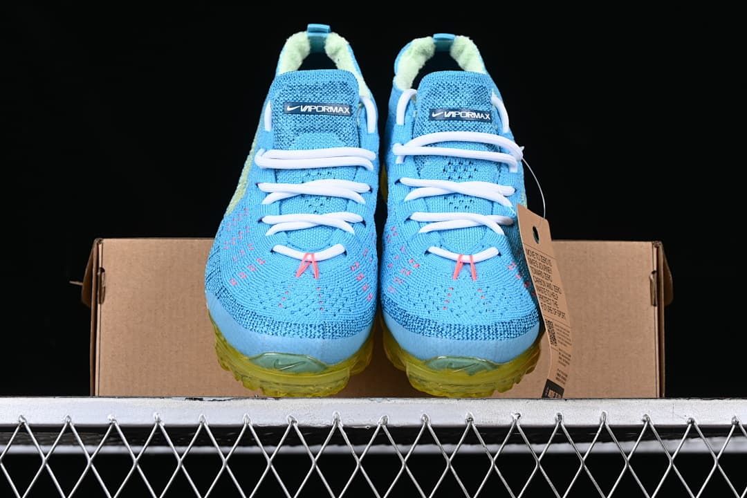 Front view of the pair showing blue knit uppers, white laces and yellow soles.