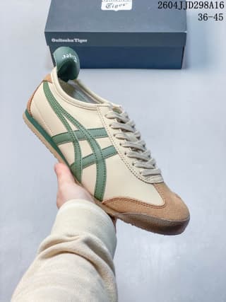Cream-colored Mexico 66 sneaker with green side stripes and brown toe and heel accents.