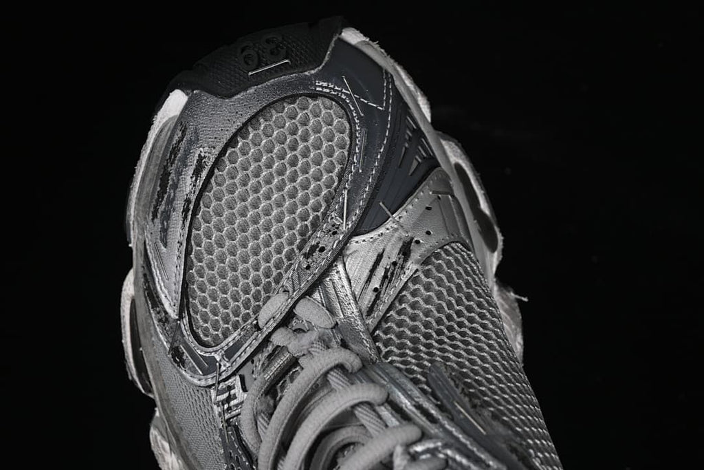 Angled close-up of the sneaker toe and mesh-look upper