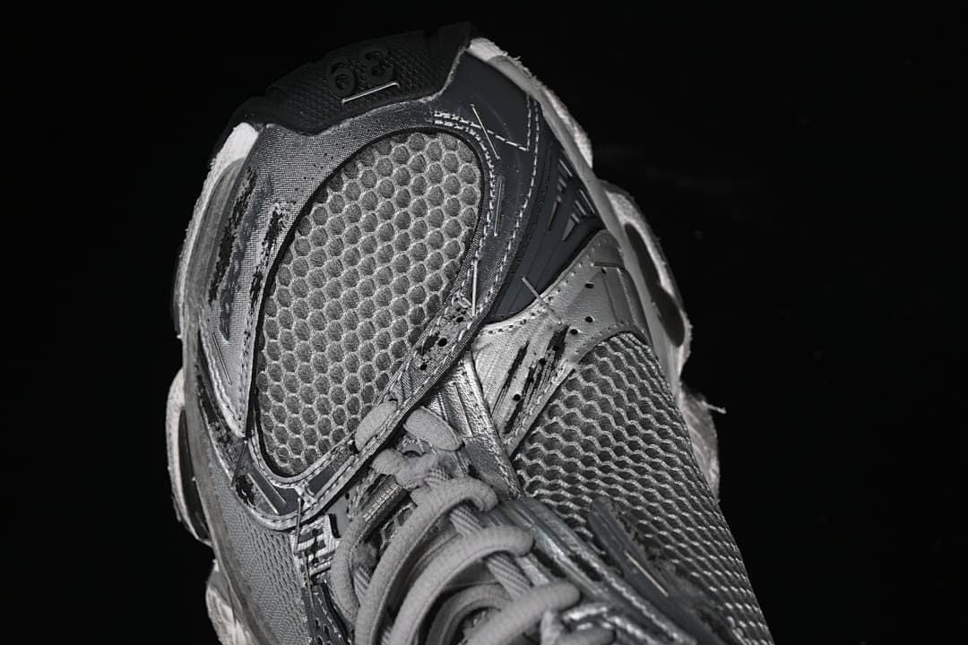 Angled close-up of the sneaker toe and mesh-look upper