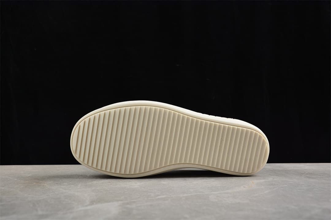 Underside showing the sneaker's ridged off-white outsole