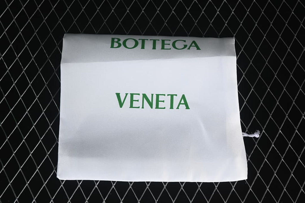 White drawstring dust bag with green Bottega Veneta lettering.