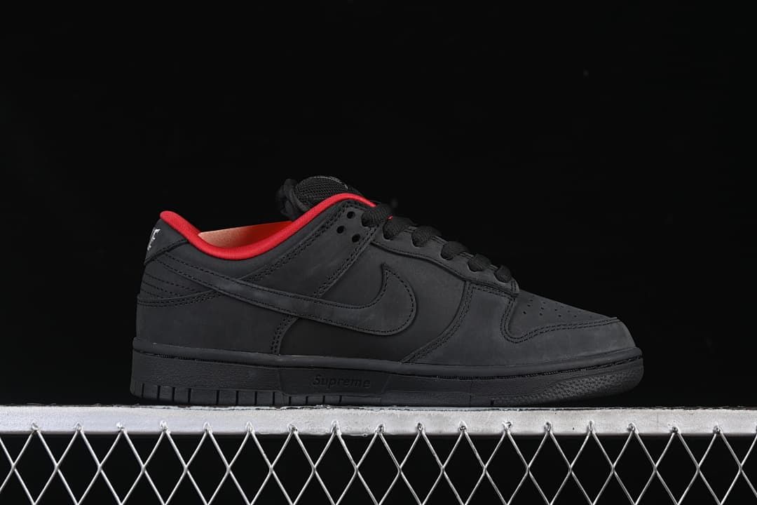 Side profile of the black low-top sneaker with red collar lining