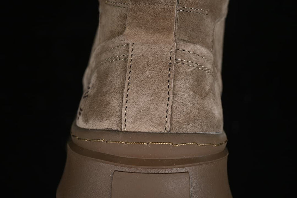 Close-up of the boot heel, stitching, and thick brown sole