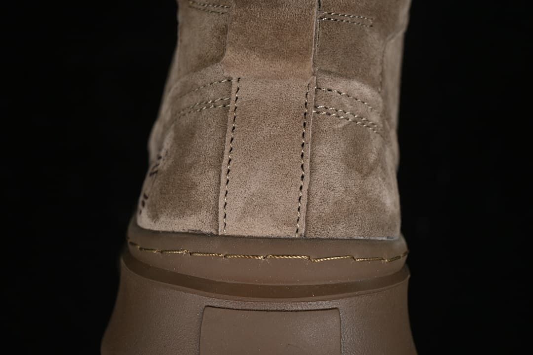 Close-up of the boot heel, stitching, and thick brown sole