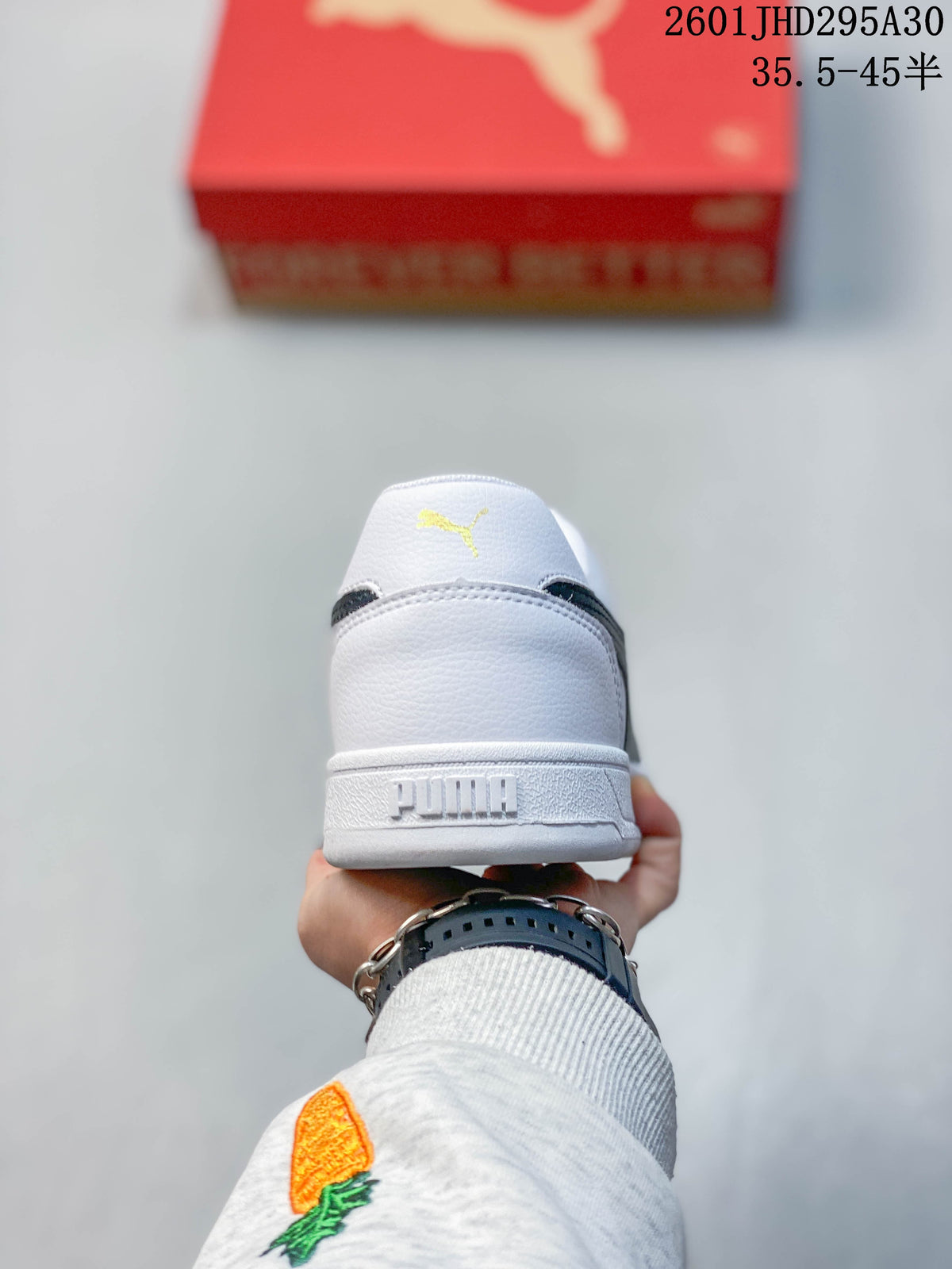 Rear view of a white Puma Caven 2.0 sneaker showing heel branding