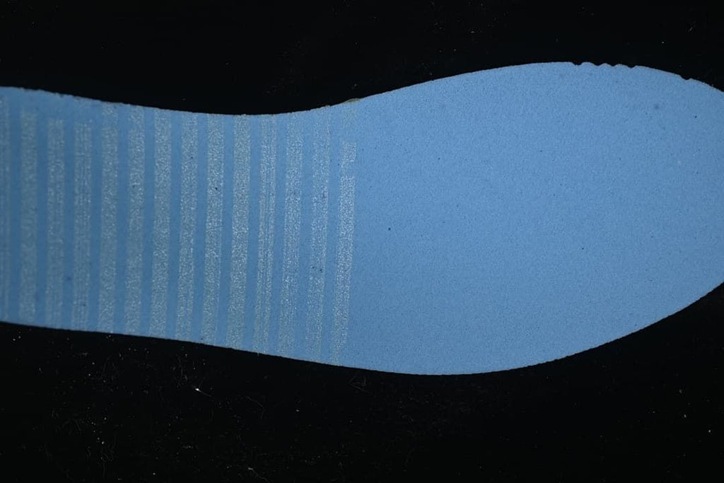 Blue-toned close-up view of the shoe outsole