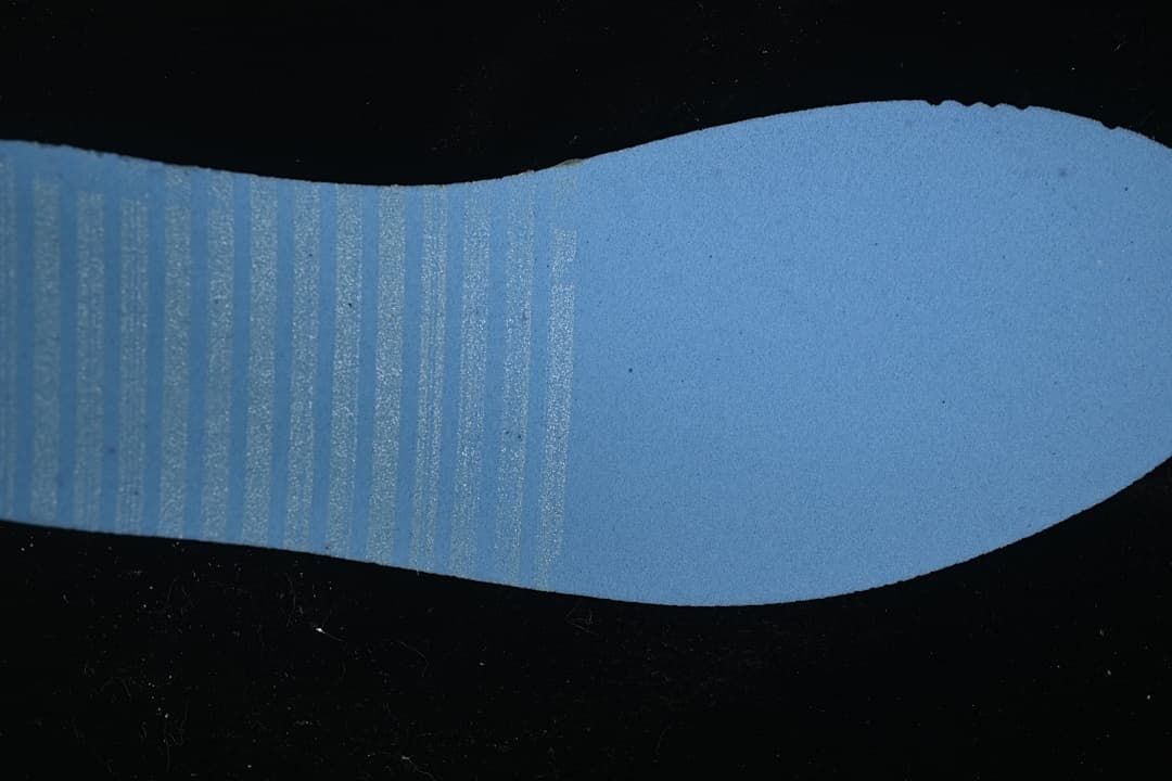 Blue-toned close-up view of the shoe outsole