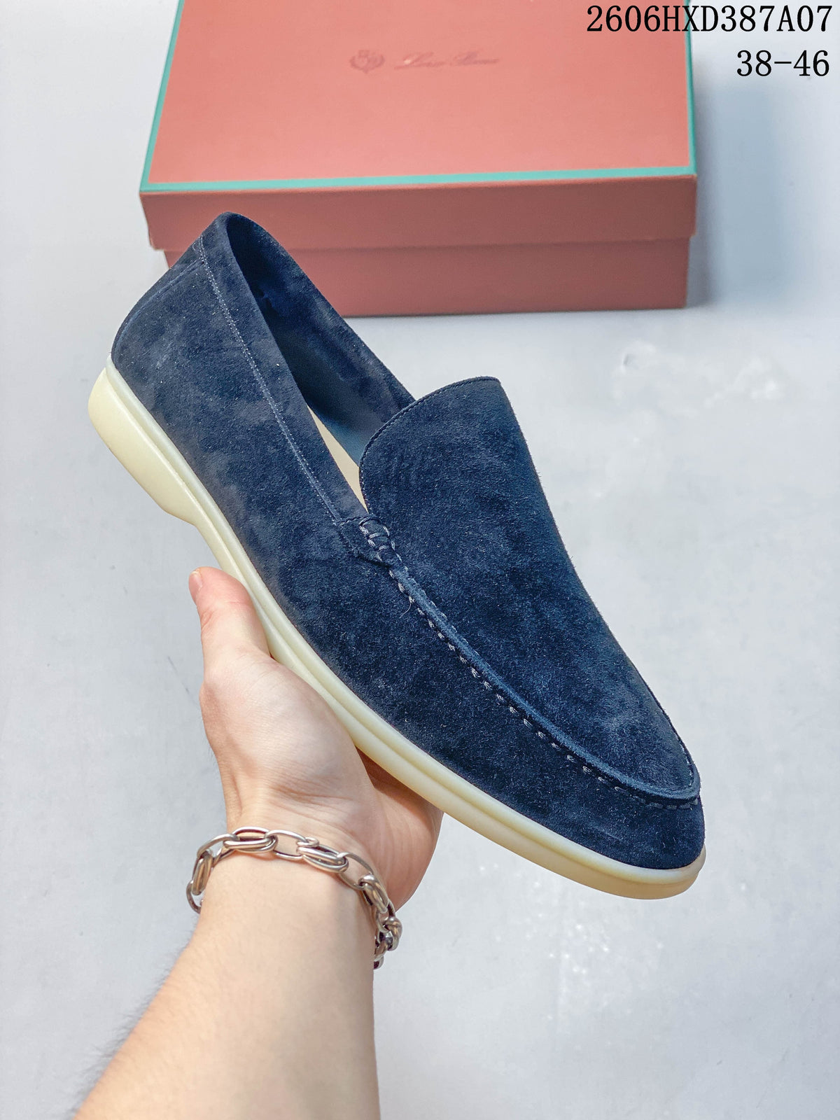 Angled view of a navy slip-on loafer with a rounded stitched toe